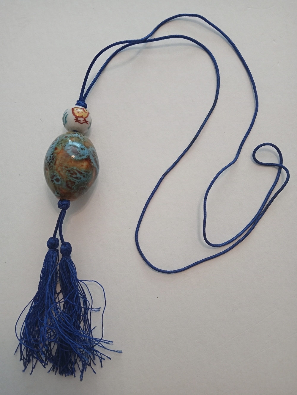 #1222.  Blue Tassel, Baby Chick & Ceramic Glazed Beaded Necklace
